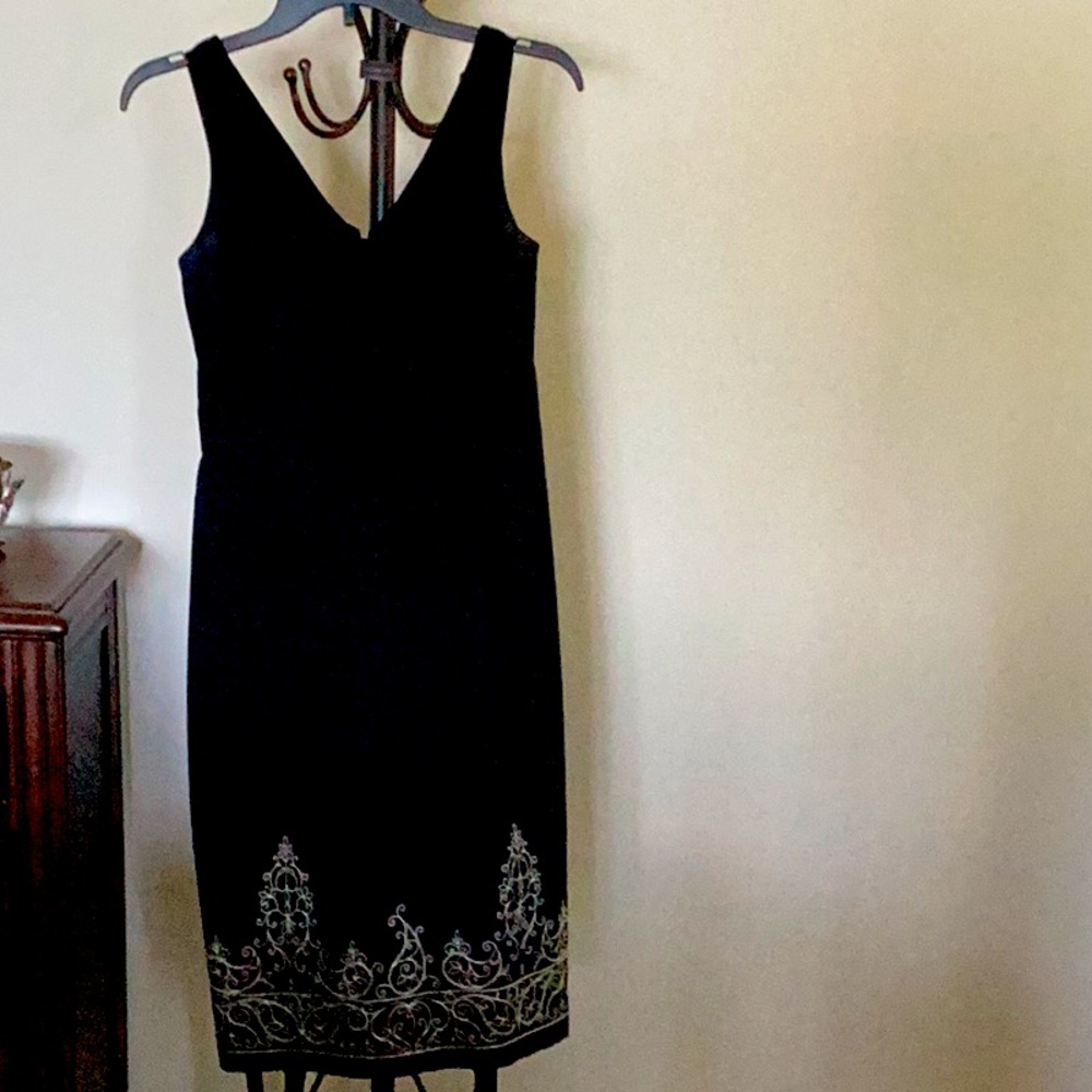 Black sleeveless dress with cream stitching on bottom